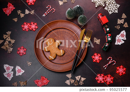 Christmas decoration elements as well as gingerbread on a brown concrete background 95025577