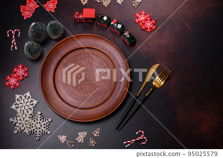 Christmas decoration elements as well as gingerbread on a brown concrete background Christmas decoration elements as well as gingerbread on a brown concrete background 95025579
