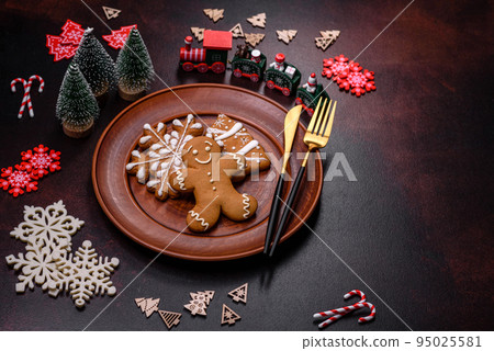 Christmas decoration elements as well as gingerbread on a brown concrete background 95025581