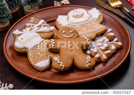 Christmas decoration elements as well as gingerbread on a brown concrete background Christmas decoration elements as well as gingerbread on a brown concrete background 95025587
