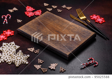 Christmas decoration elements as well as gingerbread on a brown concrete background 95025588