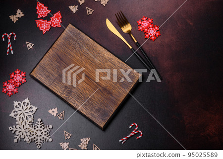 Christmas decoration elements as well as gingerbread on a brown concrete background Christmas decoration elements as well as gingerbread on a brown concrete background 95025589