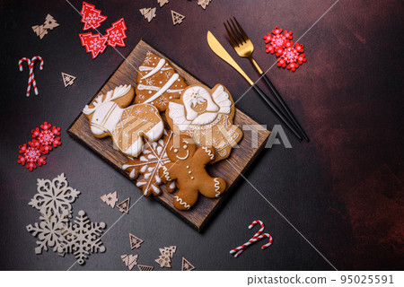 Christmas decoration elements as well as gingerbread on a brown concrete background 95025591