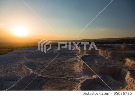 Turkey Hierapolis Pamukkale travertine terraces and the setting sun at sunset 95026780