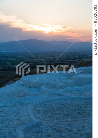 The travertine terraces of Hierapolis Pamukkale, Turkey, and the sun setting at sunset and the scenery seen from the travertine terraces The travertine terraces of Hierapolis Pamukkale, Turkey, and the sun setting at sunset and the scenery seen from the travertine terraces 95026792