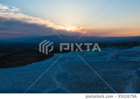 Turkey Hierapolis Pamukkale travertine terraces and the orange sky at sunset Turkey Hierapolis Pamukkale travertine terraces and the orange sky at sunset 95026796
