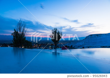 Turkey Trapetical terraces and blue water surface of Hierapolis Pamukkale at dusk 95026943
