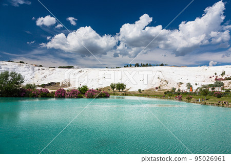 White travertine terraces and blue water ponds in Pamukkale, Hierapolis, Turkey 95026961