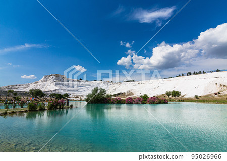 White travertine terraces and blue water ponds in Pamukkale, Hierapolis, Turkey 95026966