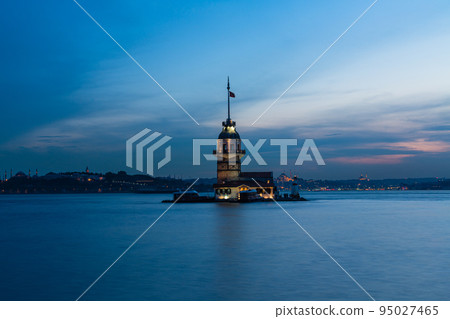 Illuminated Maiden's Tower on a small island in the Bosphorus Strait at night in Istanbul, Turkey 95027465