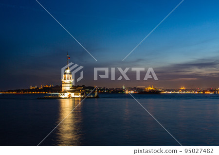 Illuminated Maiden's Tower on a small island in the Bosphorus Strait at night in Istanbul, Turkey Illuminated Maiden's Tower on a small island in the Bosphorus Strait at night in Istanbul, Turkey 95027482
