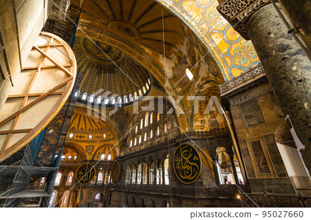 The dome of the main hall of the Hagia Sophia in Istanbul, Turkey, and a disk engraved with Arabic letters 95027660