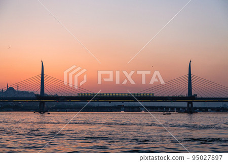 Bridge and sunset sky connecting the new and old towns over the Golden Horn in Istanbul, Turkey Bridge and sunset sky connecting the new and old towns over the Golden Horn in Istanbul, Turkey 95027897