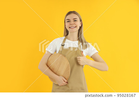 Concept of occupation, young female waiter on yellow background 95028167