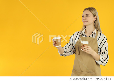 Concept of occupation, young female waiter on yellow background 95028174