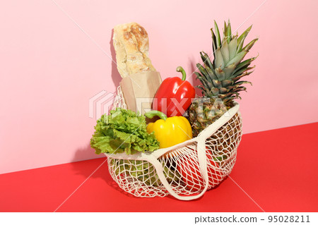 String bag with grocery on two tone background 95028211