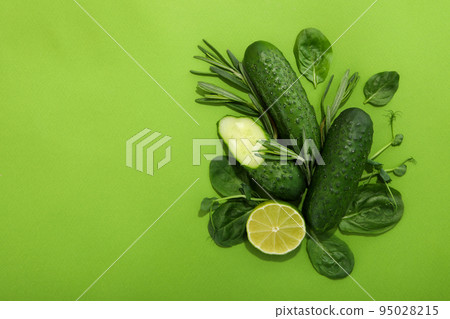 Flat lay with green food on green background 95028215
