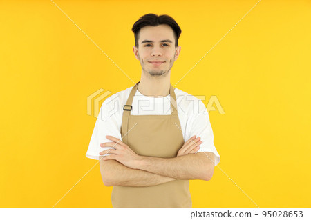 Concept of cooking, young man chef on yellow background Concept of cooking, young man chef on yellow background 95028653