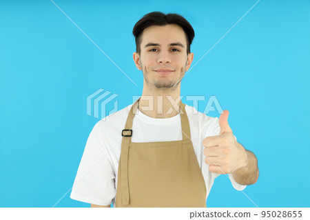 Concept of cooking, young man chef on blue background Concept of cooking, young man chef on blue background 95028655