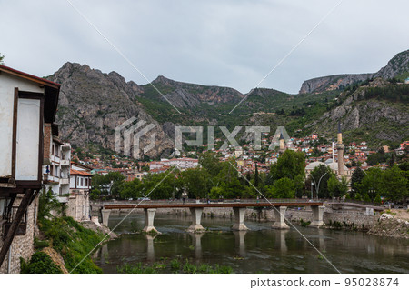 Cityscape surrounded by mountains and the Yesil River flowing through Amasya, Turkey Cityscape surrounded by mountains and the Yesil River flowing through Amasya, Turkey 95028874