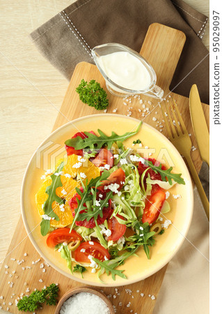 Concept of tasty food with salad with red orange Concept of tasty food with salad with red orange 95029097