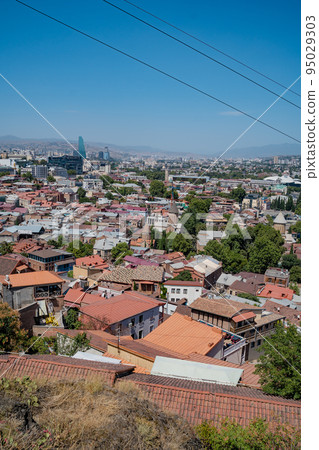 Tbilisi, Georgia - October 1 2022: Beautiful panoramic aerial view of Tbilisi at sunset Tbilisi, Georgia - October 1 2022: Beautiful panoramic aerial view of Tbilisi at sunset 95029303