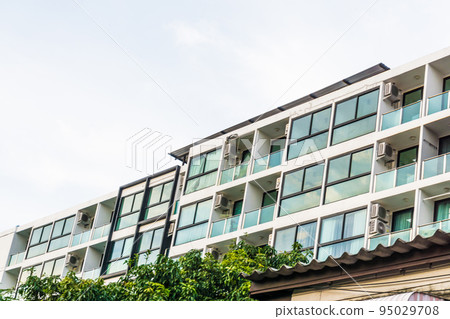 Modern real estate condominium building with blue window 95029708