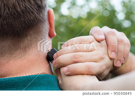 The criminal hits the man in the neck with a stun gun The criminal hits the man in the neck with a stun gun 95030845