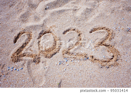 New Year 2023. Figures on the sandy shell seashore New Year 2023. Figures on the sandy shell seashore 95031414