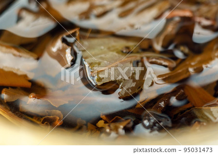 Chinese fermented pu-erh black tea close-up, macro. Selective focus Chinese fermented pu-erh black tea close-up, macro. Selective focus 95031473