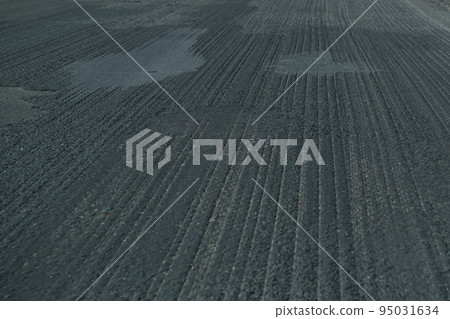 Old asphalt. Budget repair of the road. Broken Old asphalt. Budget repair of the road. Broken 95031634