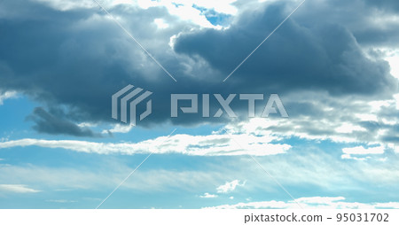 Blue sky with thunderclouds. The sun breaks Blue sky with thunderclouds. The sun breaks 95031702