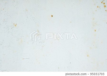 Corrosion of metal. Rust shows through the white Corrosion of metal. Rust shows through the white 95031703