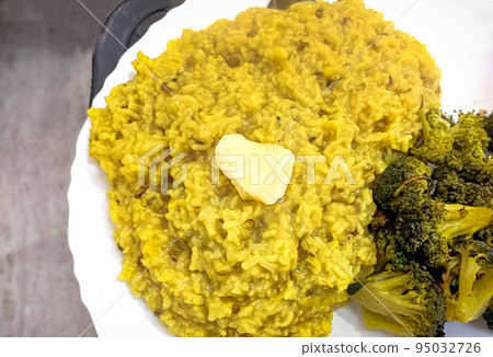 Dal khichdi or Khichadi with broccoli curry Tasty Indian recipe served in plate Dal khichdi or Khichadi with broccoli curry Tasty Indian recipe served in plate 95032726
