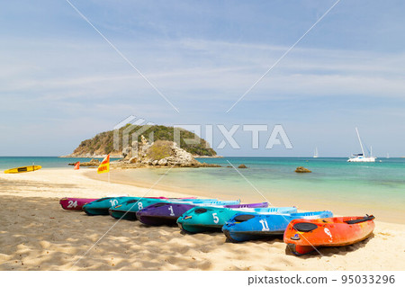 A row of kayak ready to be rented at Yanui beach Phuket Thailand, destination tropical beach for tourist with the blue ocean in Thailand 95033296