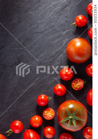 Fresh tomato on black slate background table. Tomatoes on tabletop 95033934