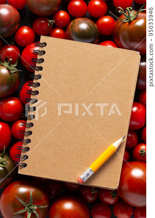 Blank recipe book and fresh tomato on table. Tomatoes with cookbook at tabletop top view 95033946