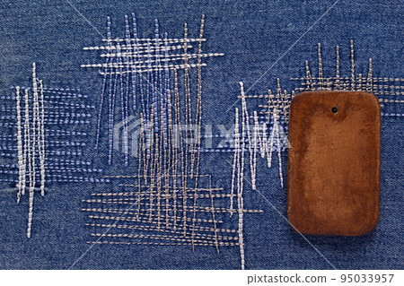 Wooden price tag label on jeans background texture. Blue jeans denim fabric Wooden price tag label on jeans background texture. Blue jeans denim fabric 95033957