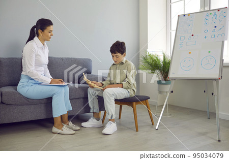 Psychologist, school counselor or teacher communicating with little school child Psychologist, school counselor or teacher communicating with little school child 95034079
