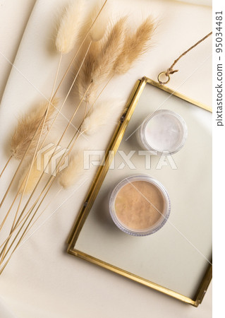 Face powder for make up in boxes on natural background with dried flowers. Aesthetics of makeup artist cosmetic beauty top view 95034481