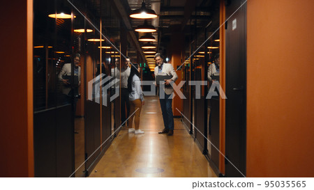 Fired man in office hallway with box of books 95035565