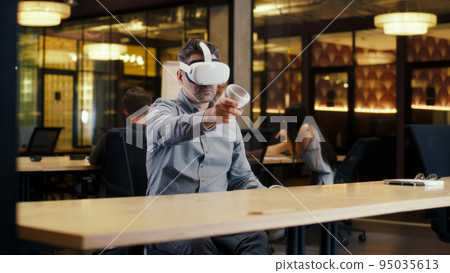 Male office worker wearing VR headset Male office worker wearing VR headset 95035613
