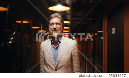 Asian businesswoman standing in office hallway Asian businesswoman standing in office hallway 95035657