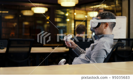 Man in VR headset in modern office 95035683
