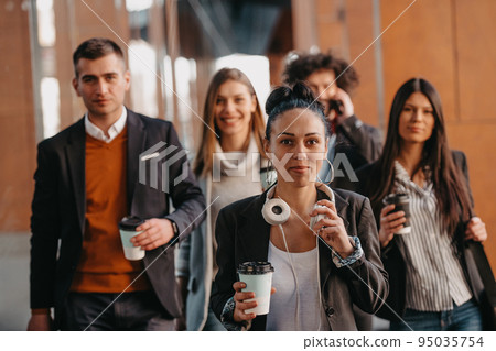 Travelers business team of colleagues walking and talking on modern urban city streets. People on out of the office on break.  95035754