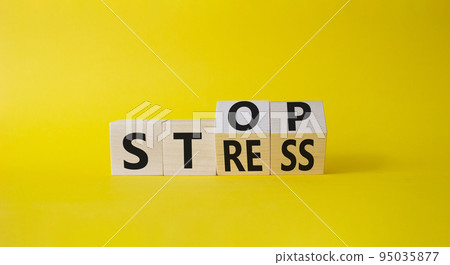 Stop and Stress symbol. Turned wooden cubes with words Stress and Stop. Beautiful yellow background. Business and Stop Stress concept. Copy space. 95035877