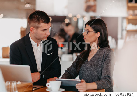 Modern man and woman use modern devices, laptop, tablet and smartphone and arrange new projects for the job. Business concept . 95035924