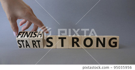 Start and Finish Strong. Businessman hand Turnes wooden cubes and changes words Start Strong to Finish Strong. Beautiful grey background. Business concept. Copy space Start and Finish Strong. Businessman hand Turnes wooden cubes and changes words Start Strong to Finish Strong. Beautiful grey background. Business concept. Copy space 95035956