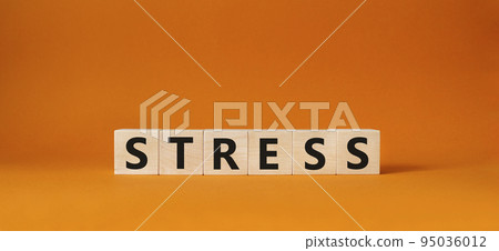 Stress symbol. Concept word Stress on wooden cubes. Beautiful orange background. Medicine and Stress concept. Copy space. Stress symbol. Concept word Stress on wooden cubes. Beautiful orange background. Medicine and Stress concept. Copy space. 95036012