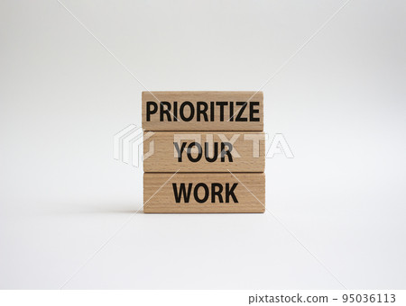 Priority symbol. Wooden blocks with words 'Prioritize your work'. Beautiful white background. Business and 'Prioritize your work' concept. Copy space. 95036113